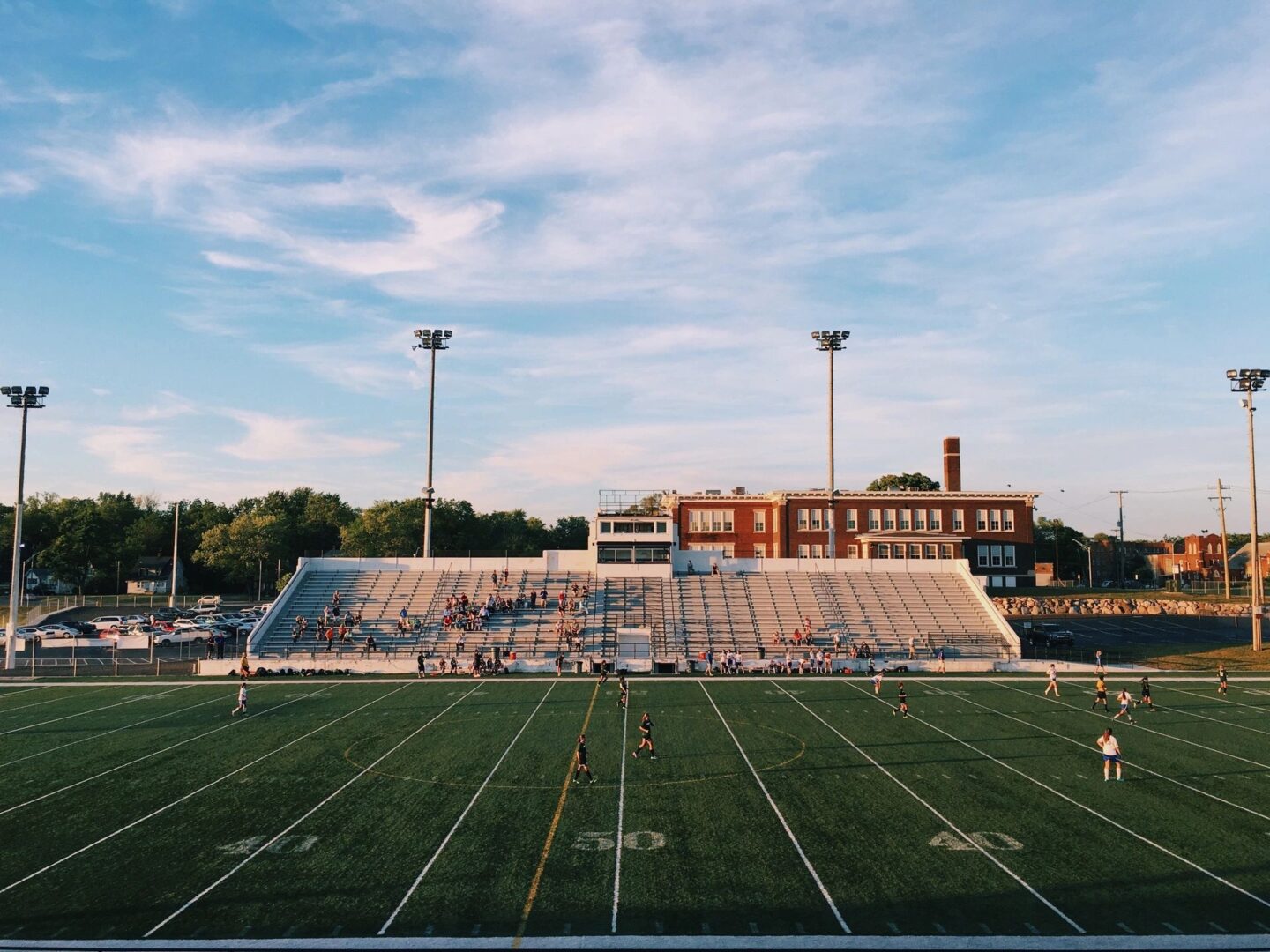 A football field with bleachers and fans in the background.
